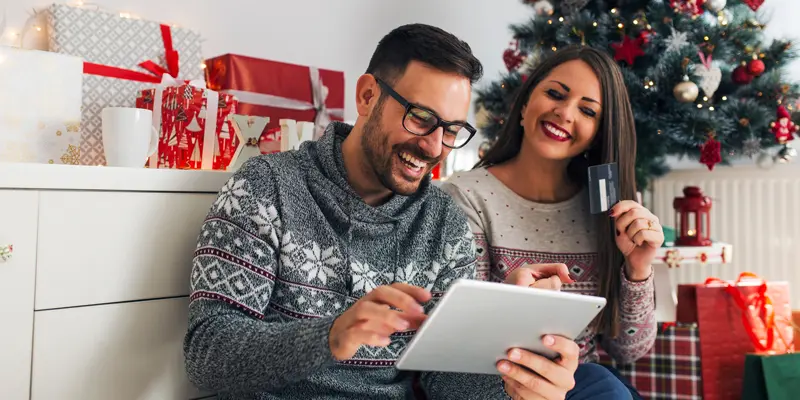 A happy couple buying gifts online