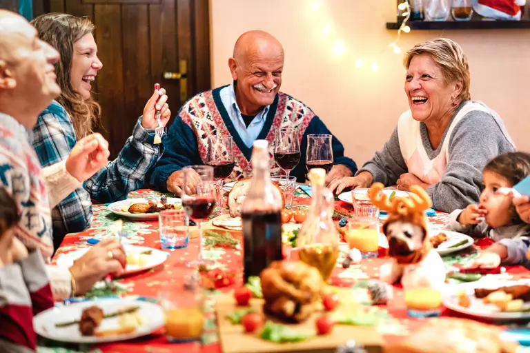 Multi-generational family having Christmas dinner together.