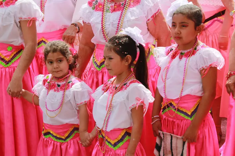 Young Mexican girls in traditional costumes for a festival.